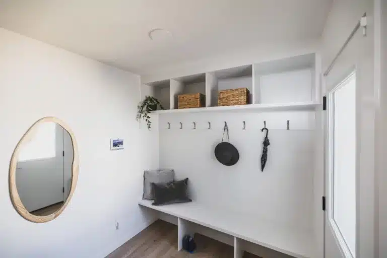 Entryway and built‑in storage bench inside Cantiro homes Rosenthal showcasing functional design for West Edmonton living