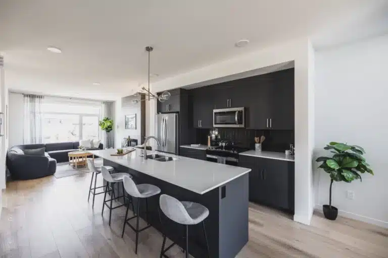 Modern open‑concept kitchen and living area in Rosenthal homes for sale Edmonton by Cantiro featuring oversized island and contemporary finishes
