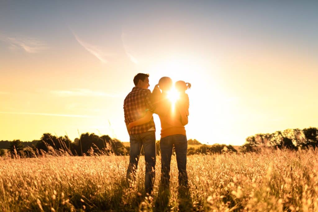 Young family in field near west edmonton community