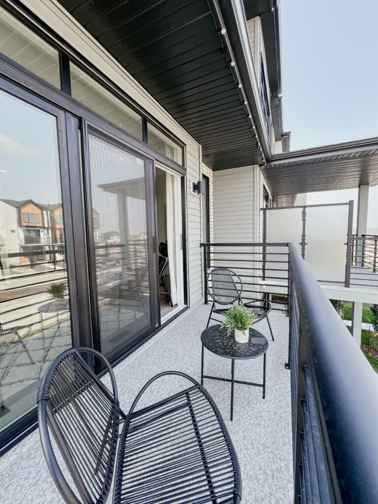 Private balcony with seating area in a Cantiro townhome in the Roseburn community, Fort Saskatchewan, Alberta.