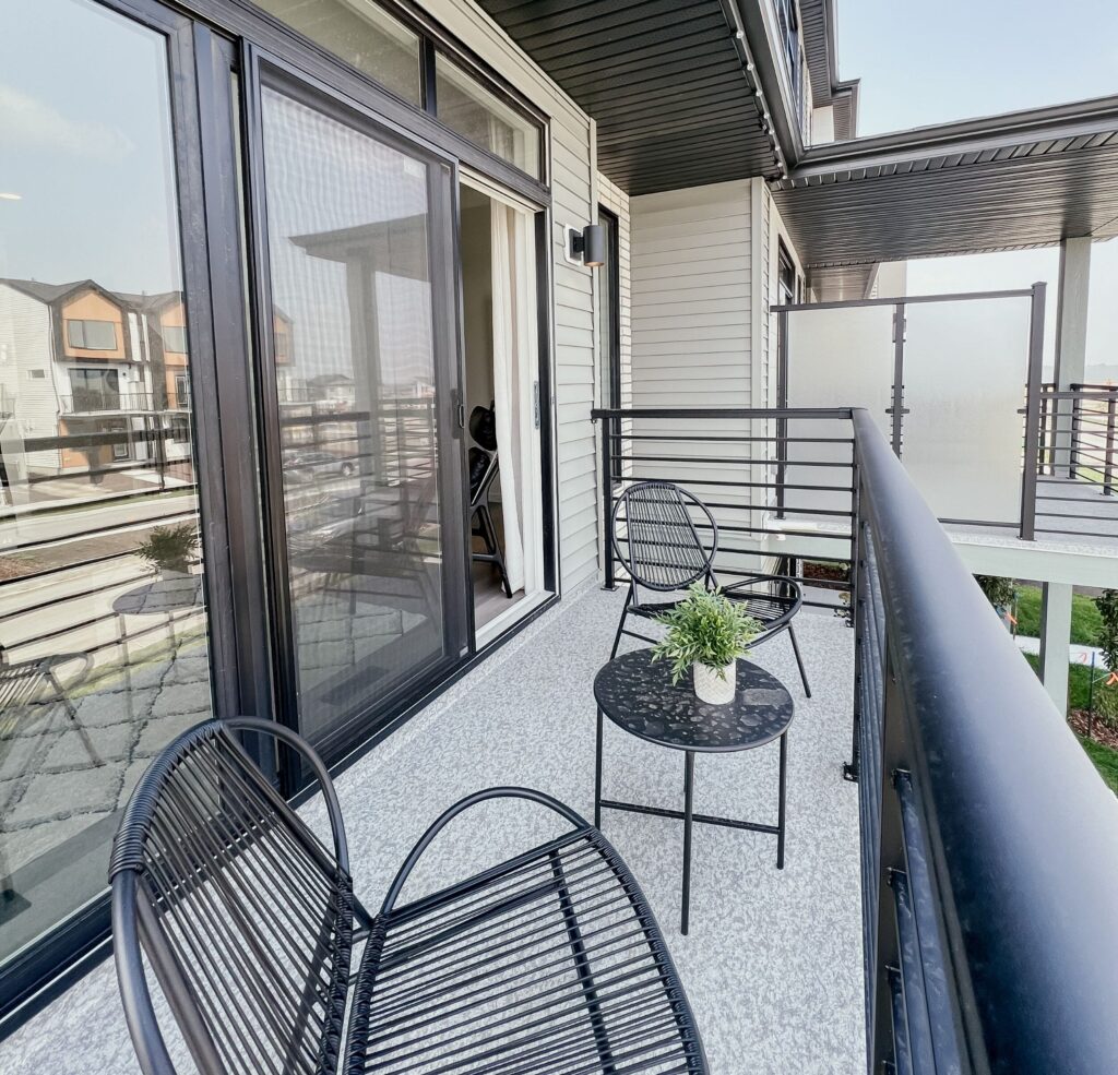 Private balcony with seating area in a Cantiro townhome in the Roseburn community, Fort Saskatchewan, Alberta.