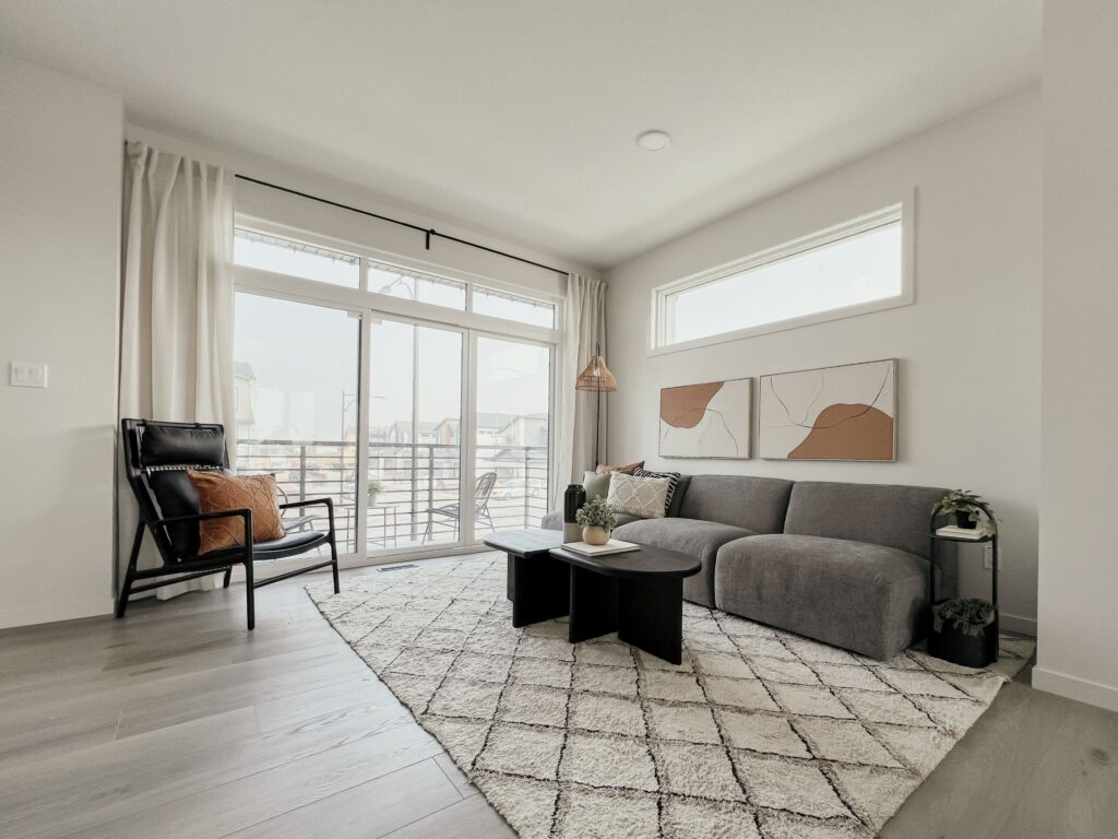 Bright living room interior with modern furnishings in a Cantiro townhome in the Roseburn community, Fort Saskatchewan, Alberta.