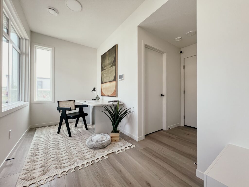 Home office or flex space with desk and natural light in a Cantiro townhome.