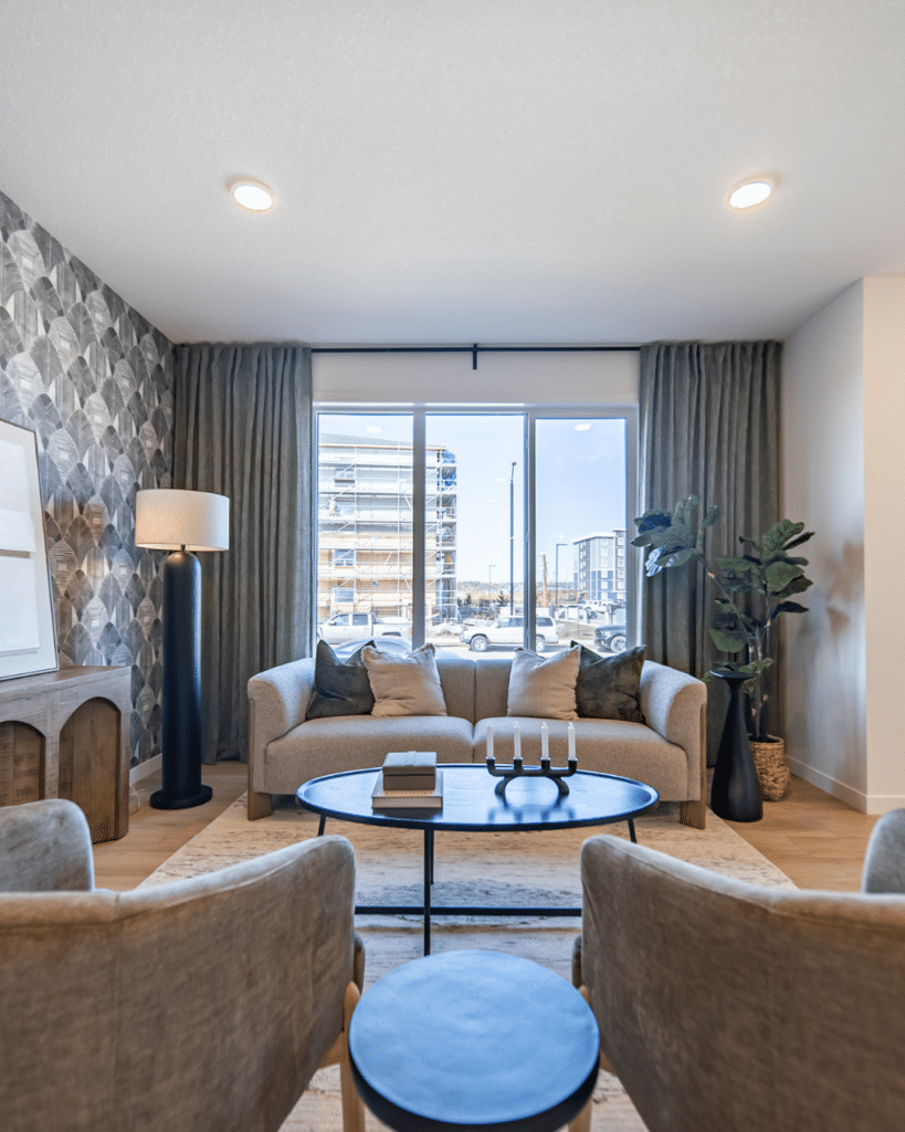 Bright living room with large windows in Edmonton condo supporting low-maintenance downsizing lifestyle