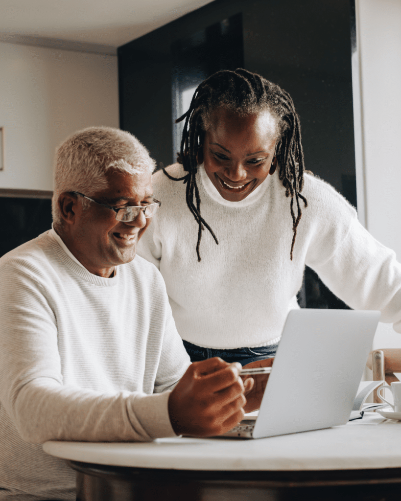 Seniors reviewing finances or housing options online while planning a downsizing move in Edmonton