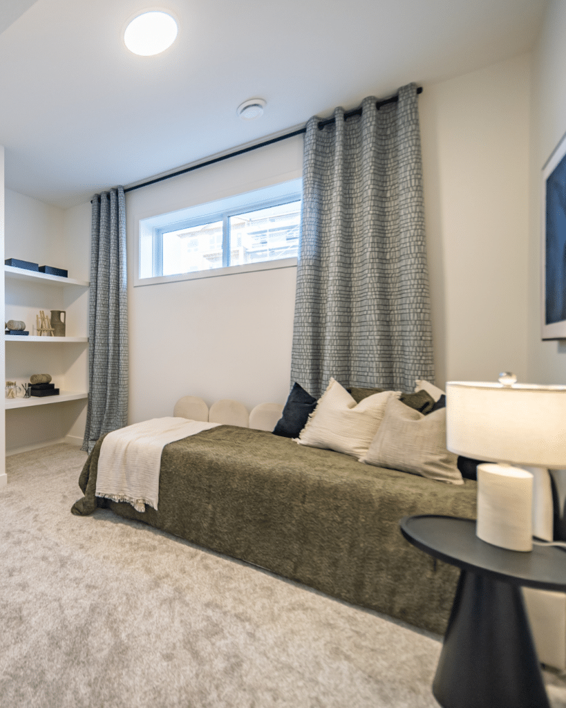 Cozy secondary bedroom in downsized Edmonton home with functional layout and minimal maintenance design