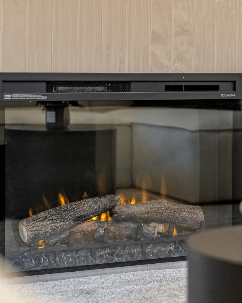 Electric fireplace detail in a low-maintenance Edmonton bungalow designed for senior downsizing comfort