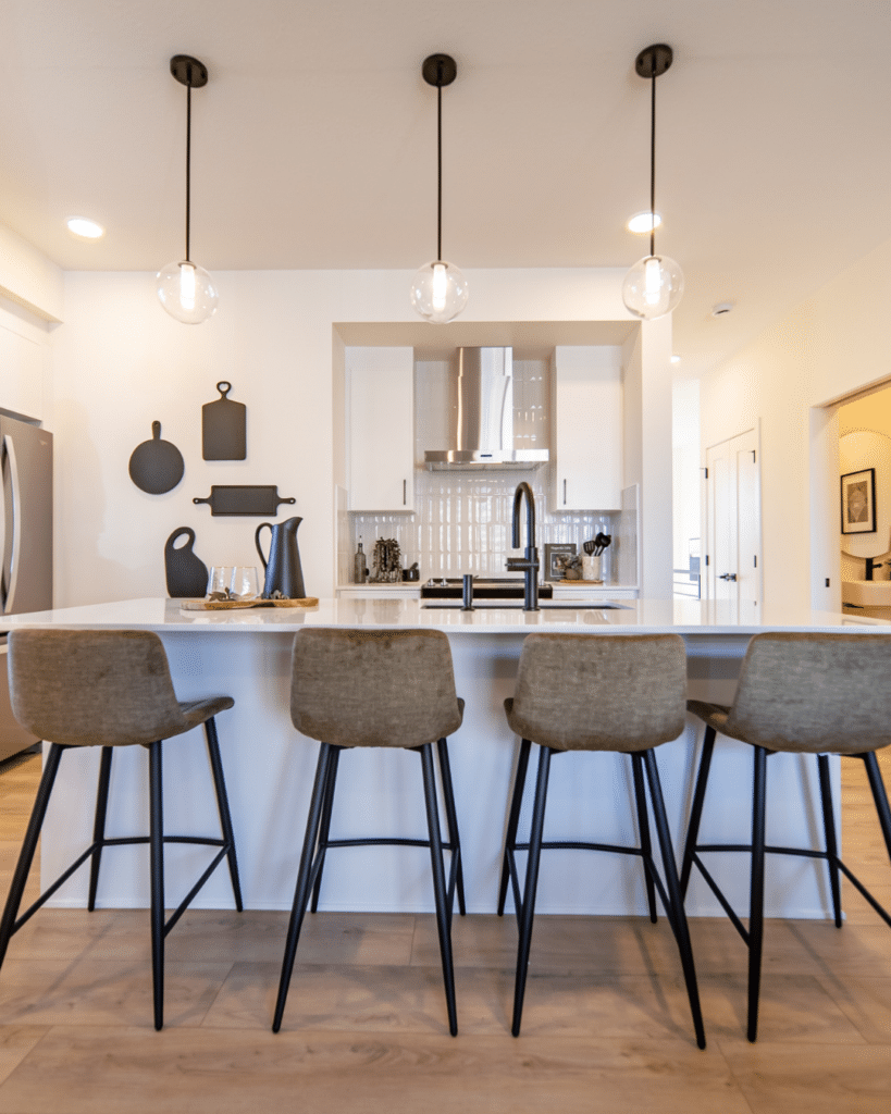 Modern kitchen with island seating in Edmonton home designed for downsizing and simplified everyday living