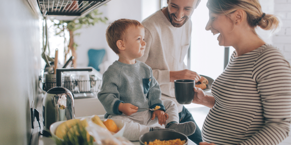 Family enjoying everyday life in a new home kitchen, illustrating real homeowner experiences with Edmonton home builders.